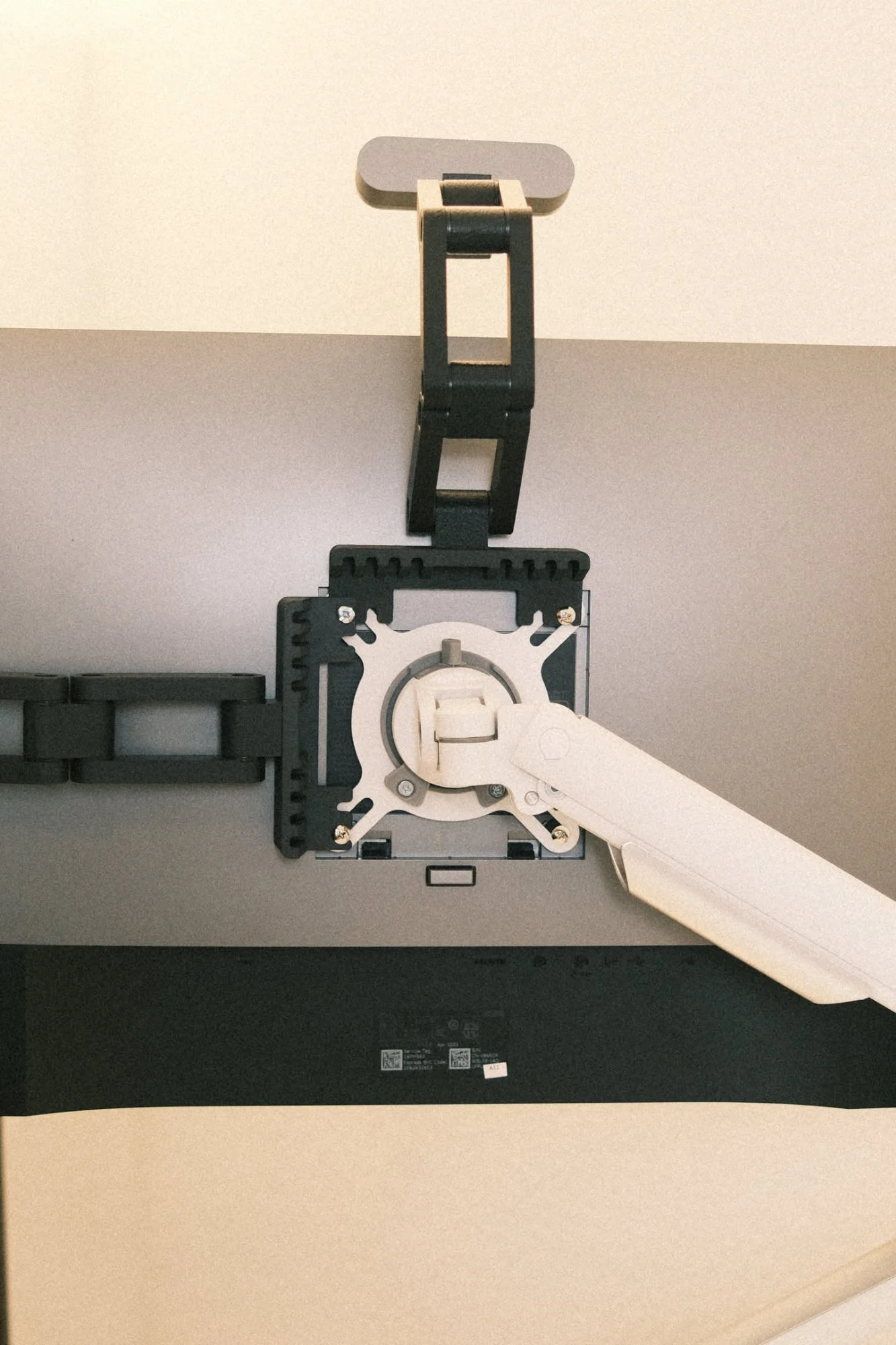 Back of monitor showing VESA plate and arm